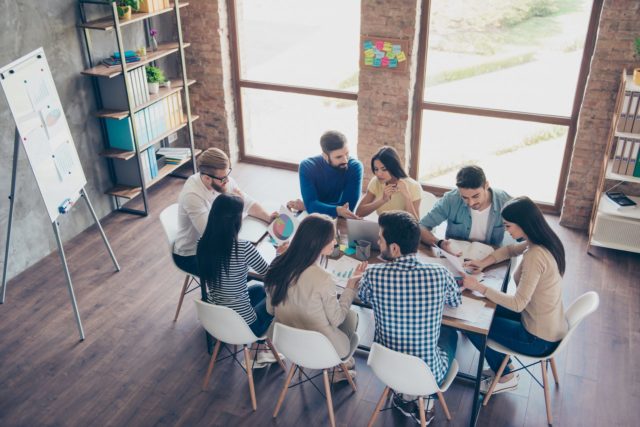 Group of people focusing round a table